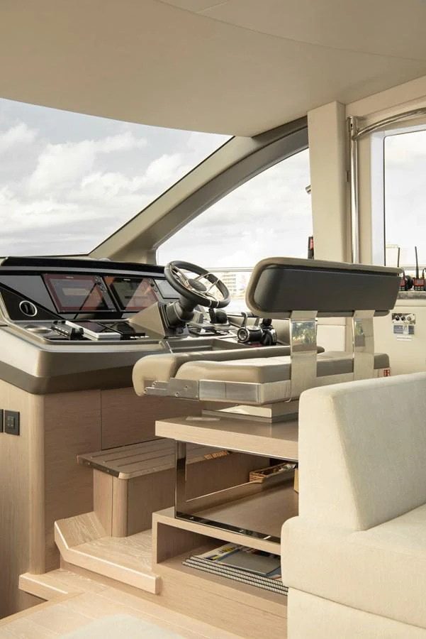 The helm station features modern controls and a comfortable captain's chair. aboard GAIA Yacht for Sale