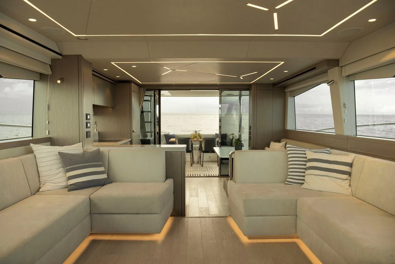 The salon features modern furnishings with ample seating and large windows offering stunning sea views. aboard GAIA Yacht for Sale