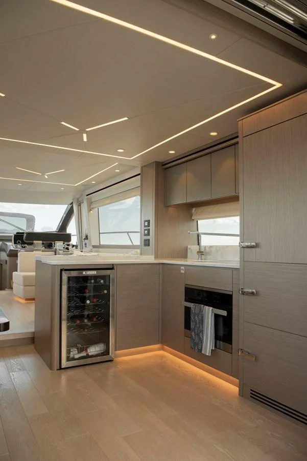The modern galley features sleek cabinetry, integrated appliances, and ambient lighting. aboard GAIA Yacht for Sale