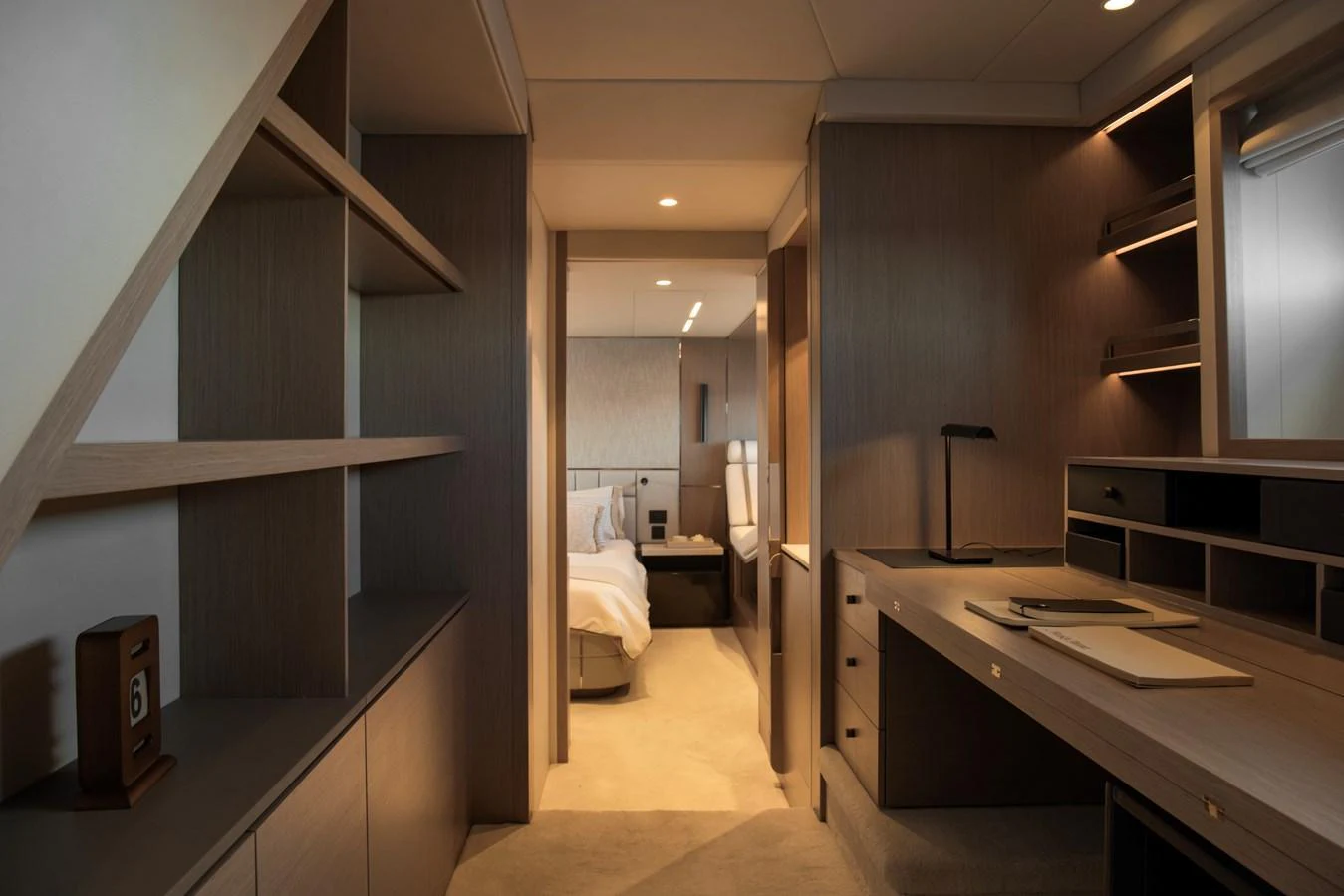 The image showcases a luxurious stateroom with elegant wood finishes and ambient lighting. aboard GAIA Yacht for Sale