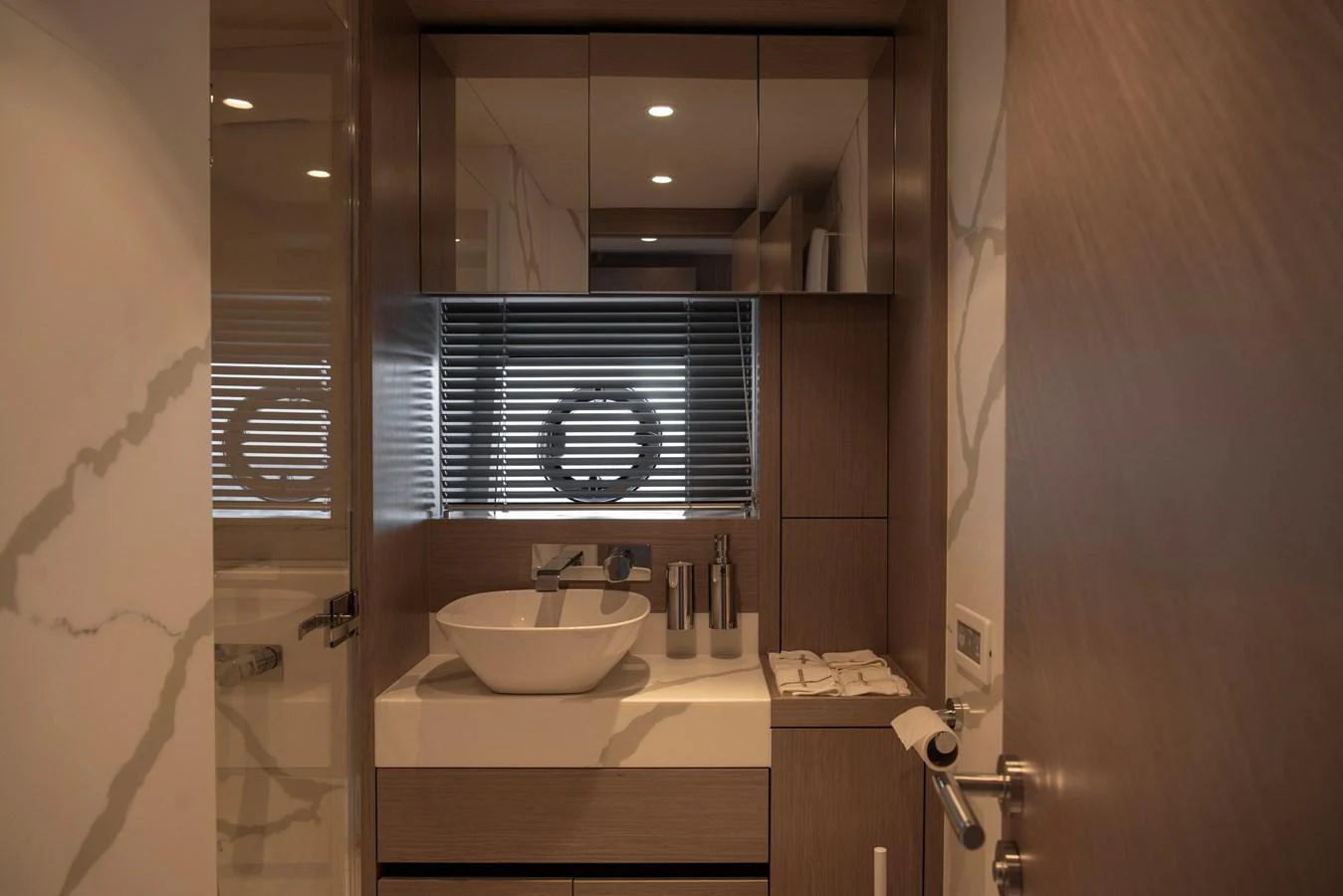 A modern and elegant yacht bathroom with sleek fixtures and warm lighting. aboard GAIA Yacht for Sale