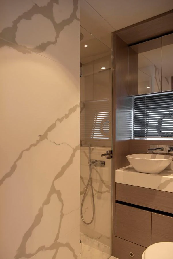The yacht's bathroom features a sleek design with modern fixtures and elegant marble accents. aboard GAIA Yacht for Sale