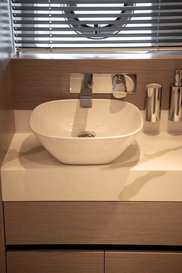 A sleek and modern bathroom sink area with elegant fixtures. aboard GAIA Yacht for Sale