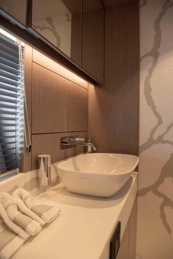 A modern yacht bathroom featuring a sleek sink and elegant finishes. aboard GAIA Yacht for Sale