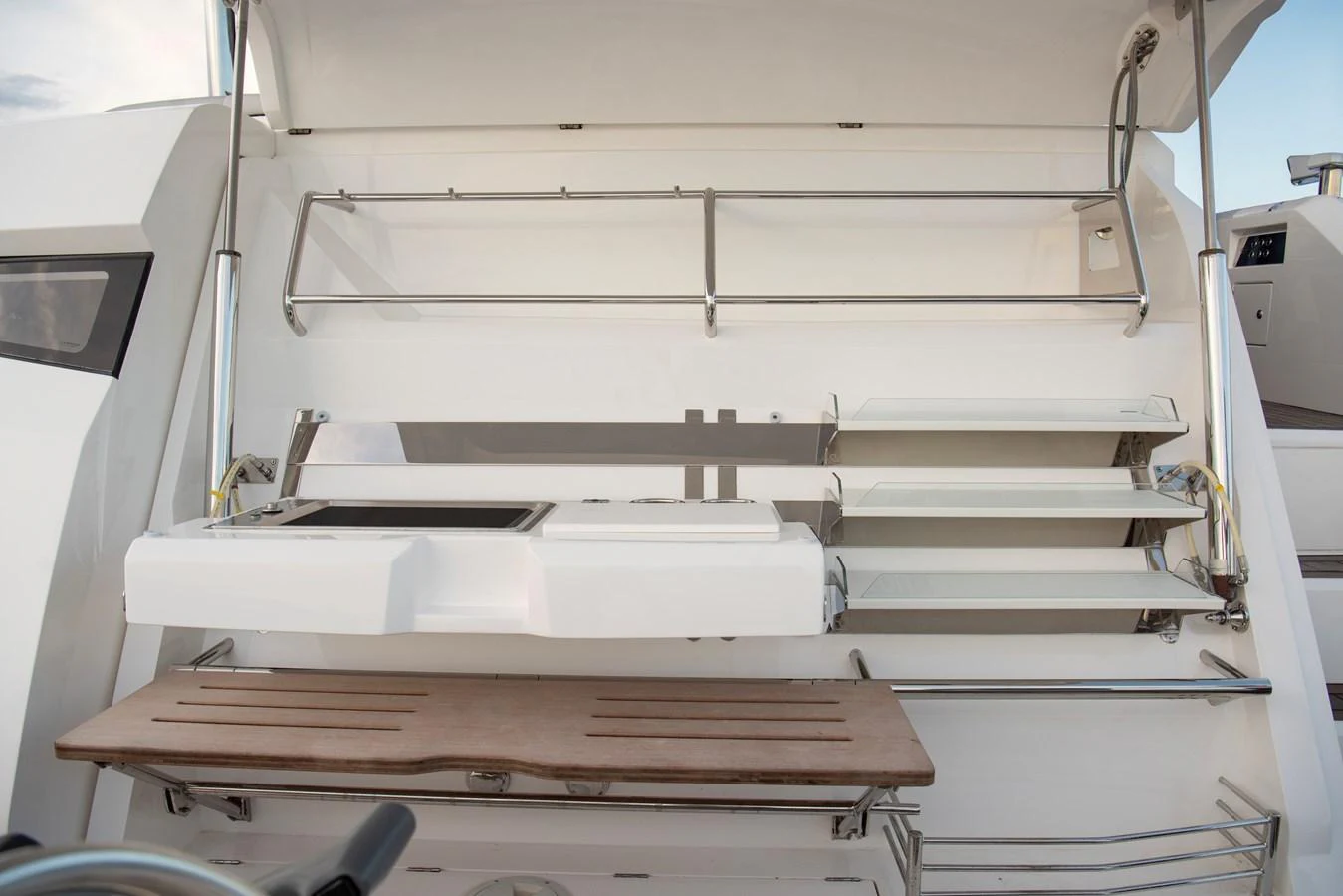This image showcases the detailed setup of a yacht's outdoor grill and storage area. aboard GAIA Yacht for Sale