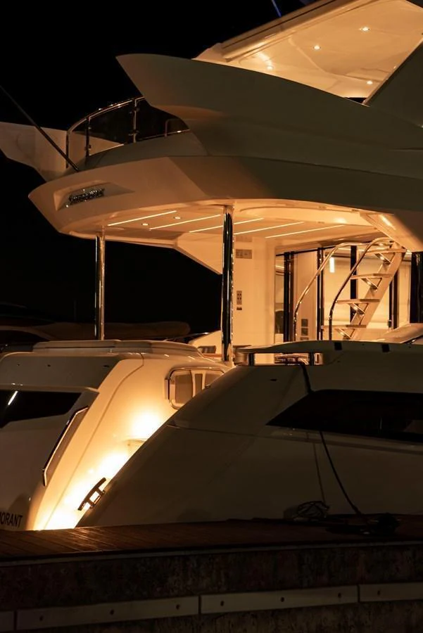 The yacht's exterior is beautifully illuminated at night, showcasing its sleek design and luxurious features. aboard GAIA Yacht for Sale