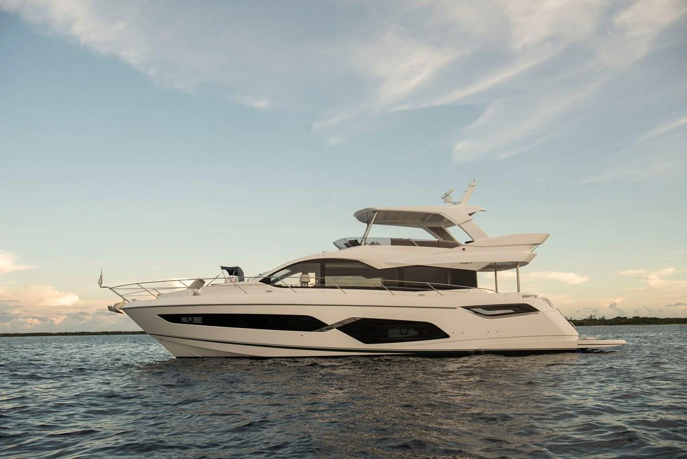 A sleek and modern yacht glides gracefully on calm waters under a serene sky. aboard GAIA Yacht for Sale
