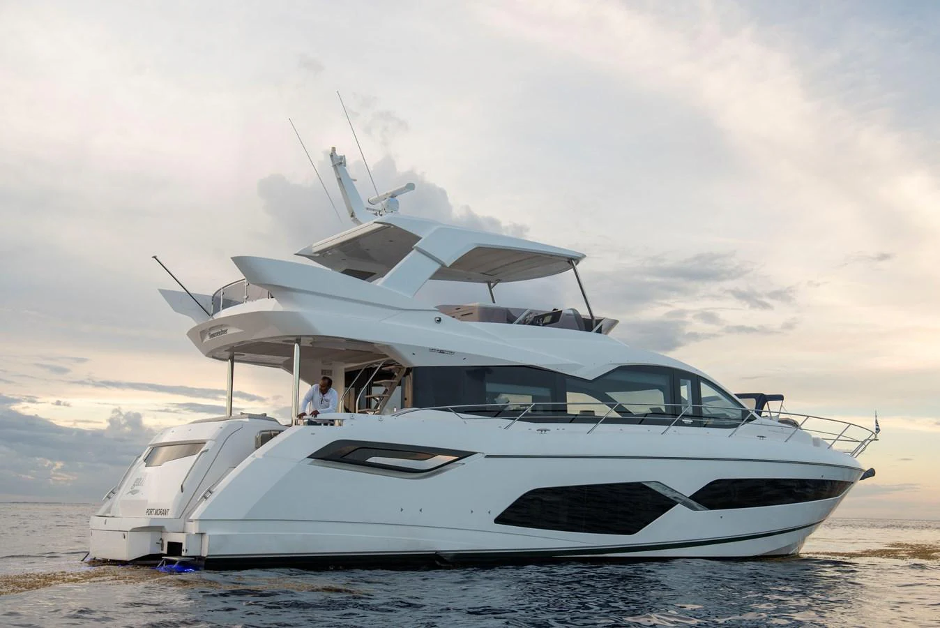 A sleek and modern yacht cruising on calm waters under a serene sky. aboard GAIA Yacht for Sale