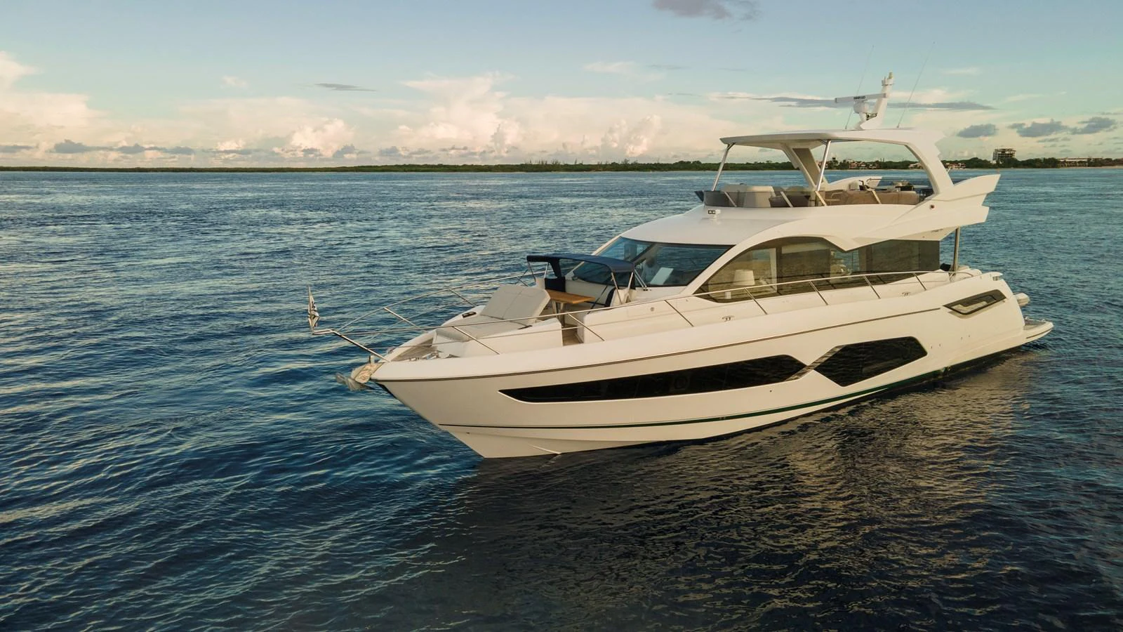 A sleek and modern yacht cruising on calm waters under a clear sky. aboard GAIA Yacht for Sale