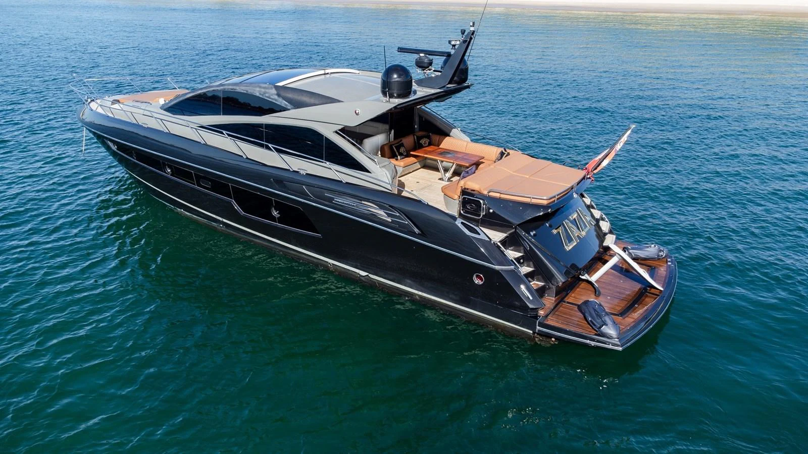 A sleek and modern yacht glides gracefully on calm waters, showcasing its luxurious design and spacious deck. aboard ZAZA Yacht for Sale