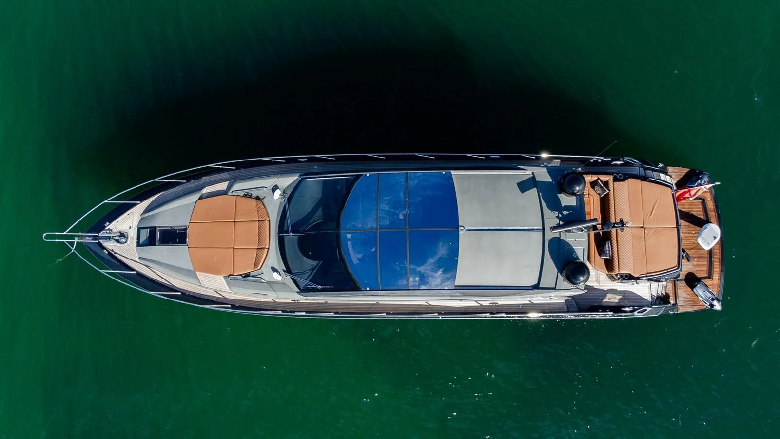An aerial view of a sleek yacht cruising on calm waters. aboard ZAZA Yacht for Sale