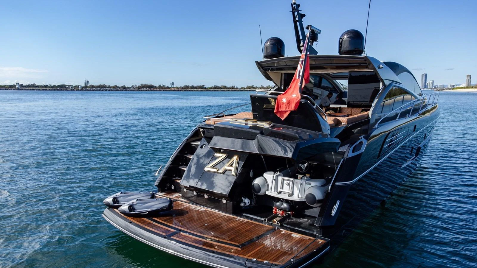 The sleek aft deck of this luxury yacht features a swim platform and modern design elements. aboard ZAZA Yacht for Sale