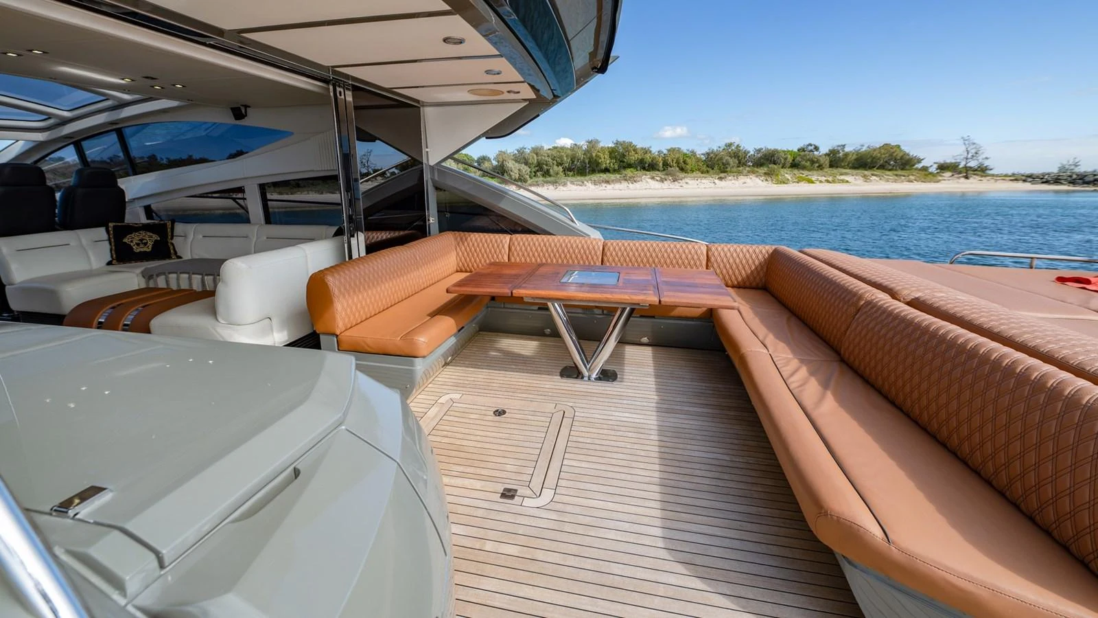 The aft deck features a spacious seating area with a wooden table, perfect for outdoor dining and relaxation. aboard ZAZA Yacht for Sale
