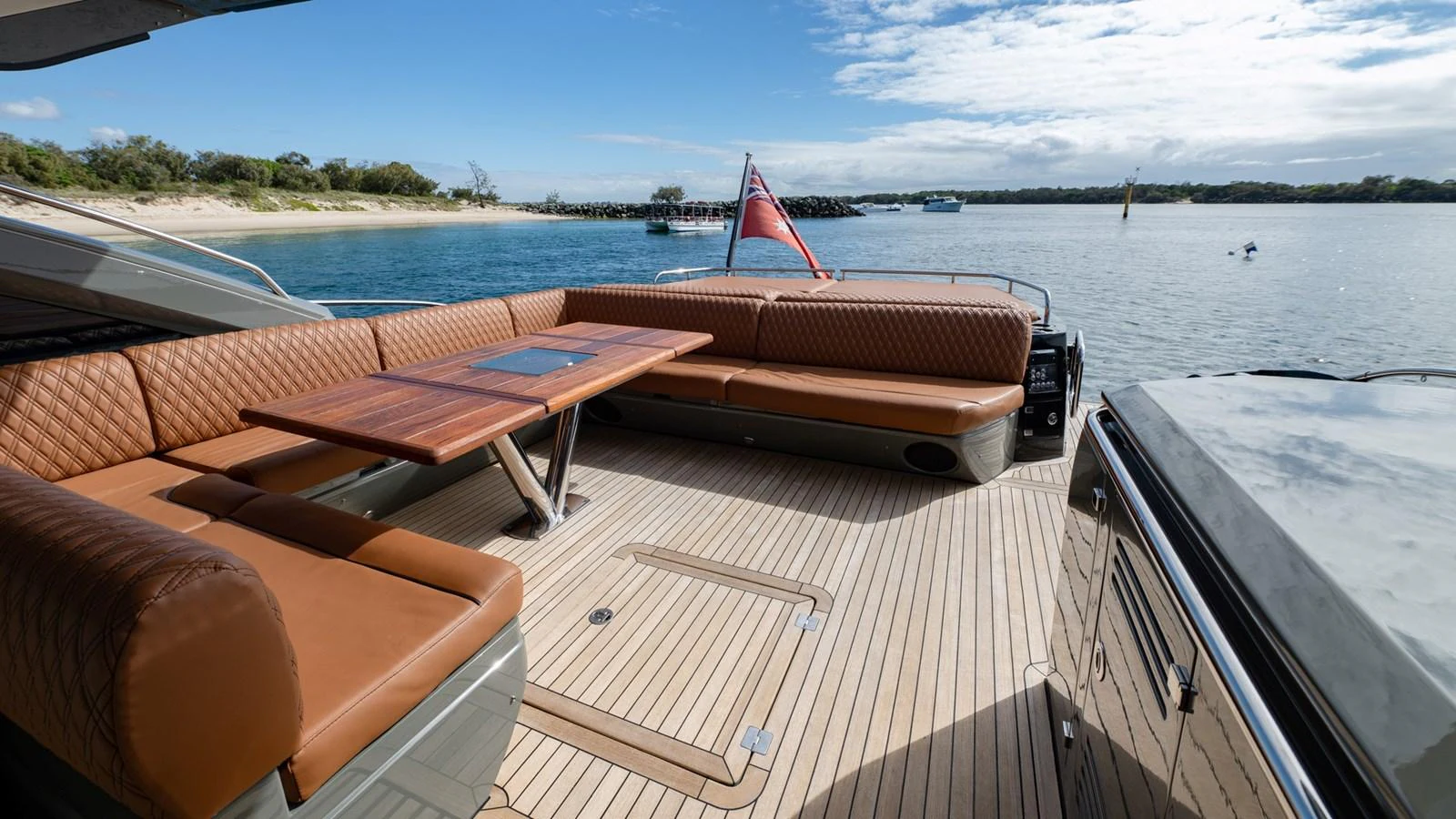 The aft deck features luxurious seating and a stylish table, perfect for outdoor relaxation and dining. aboard ZAZA Yacht for Sale