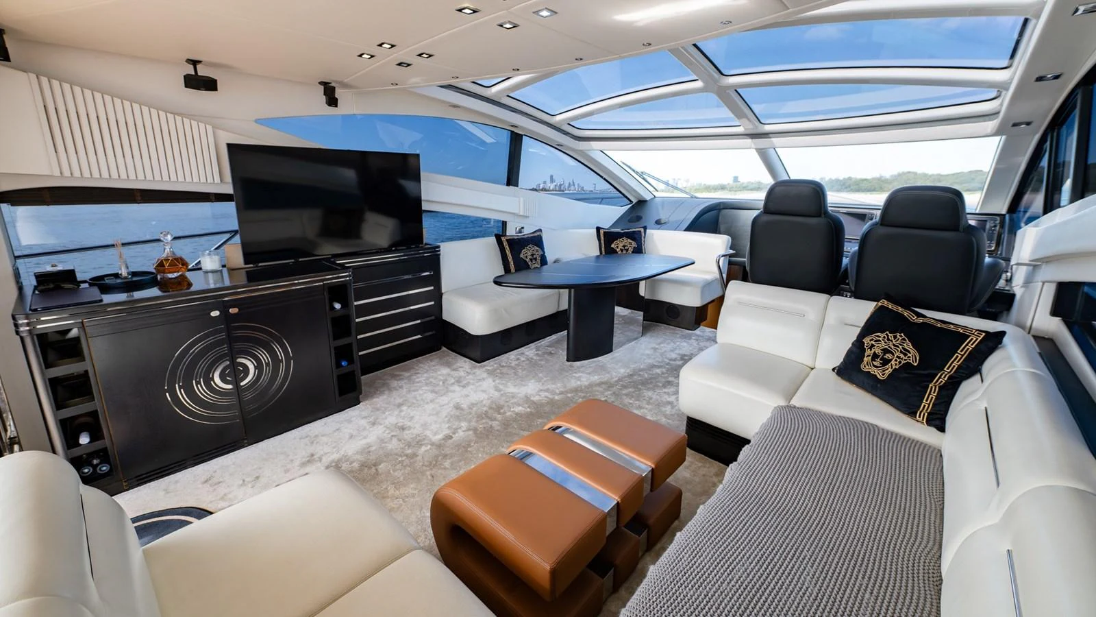 The salon features luxurious seating, a large TV, and expansive windows for panoramic views. aboard ZAZA Yacht for Sale
