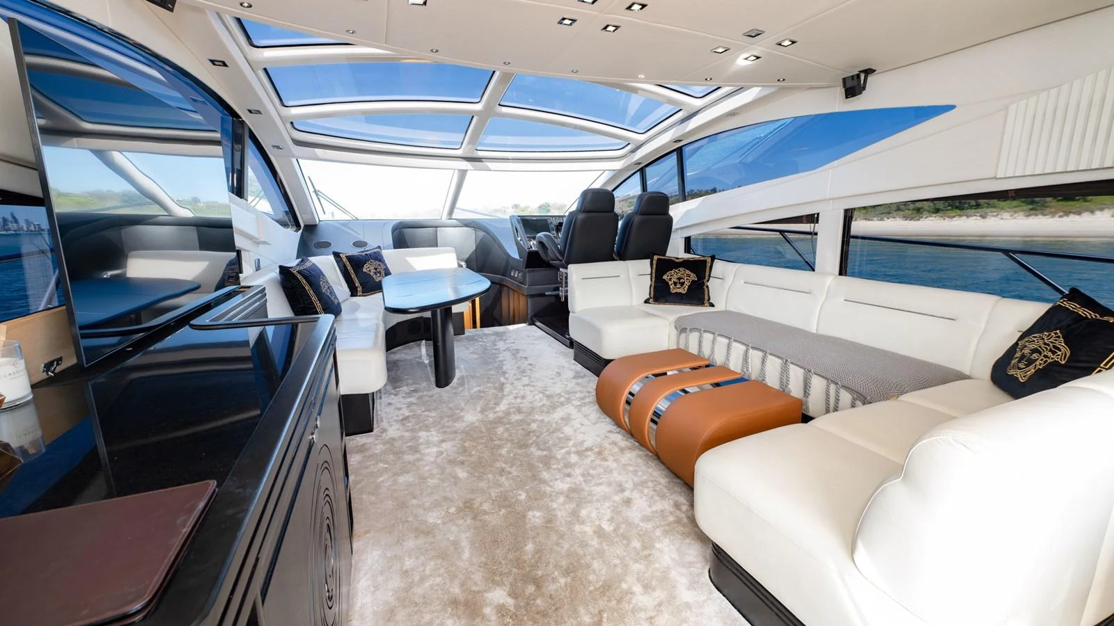 The salon features luxurious seating, a modern entertainment area, and expansive windows for panoramic views. aboard ZAZA Yacht for Sale