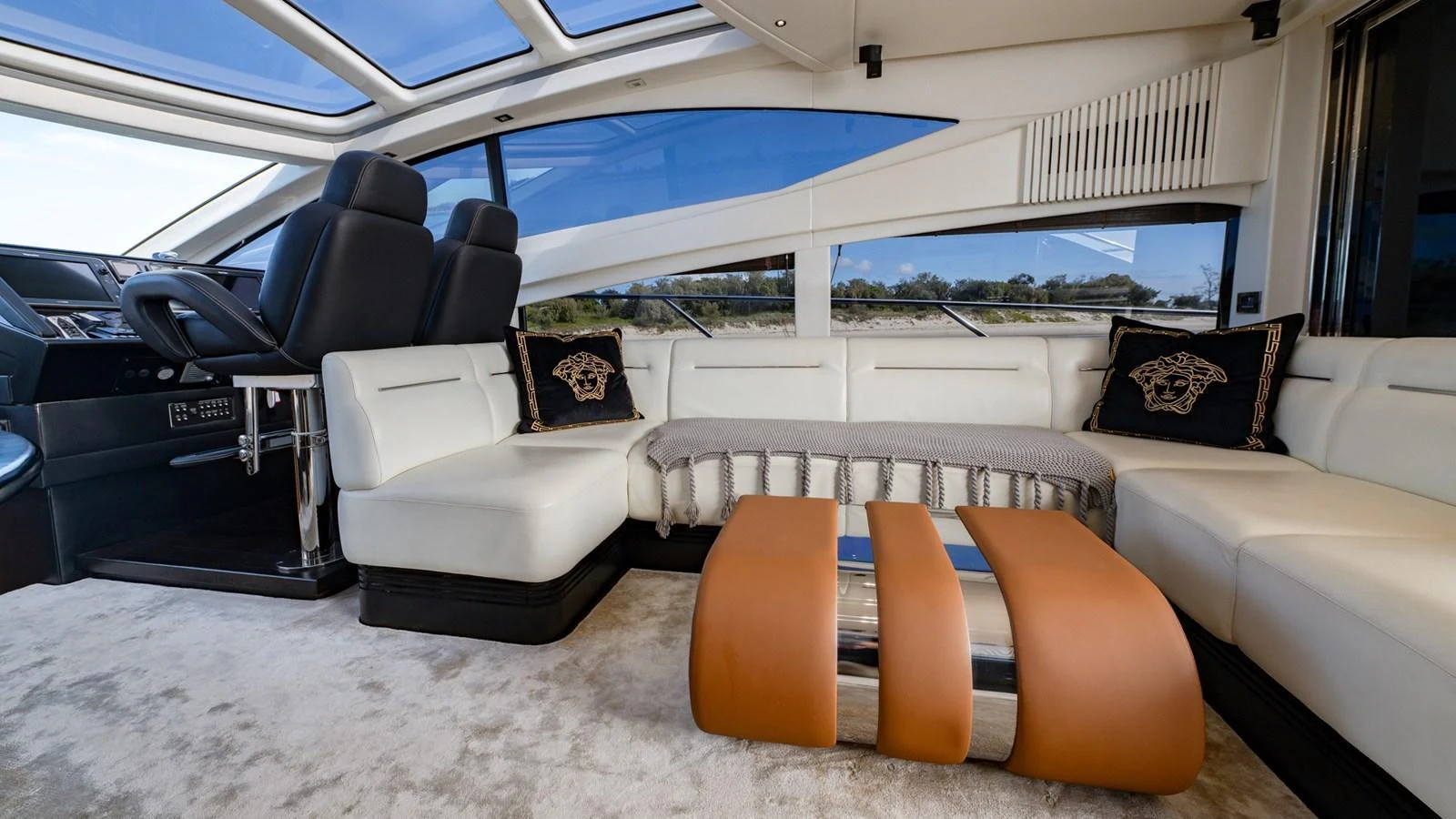 The salon features luxurious seating with panoramic windows and modern decor. aboard ZAZA Yacht for Sale