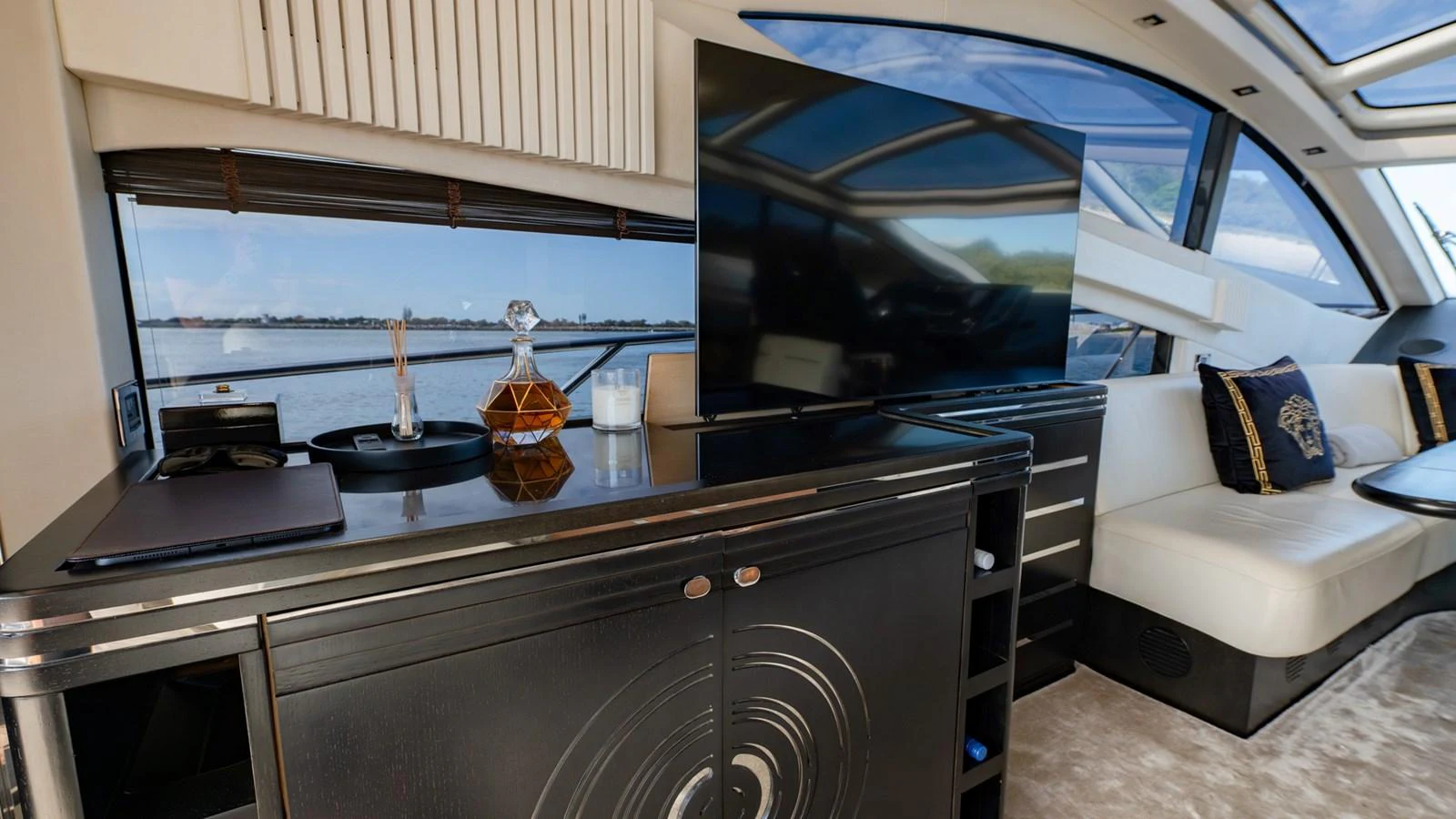 The yacht's interior features a sleek entertainment area with a large TV and comfortable seating. aboard ZAZA Yacht for Sale