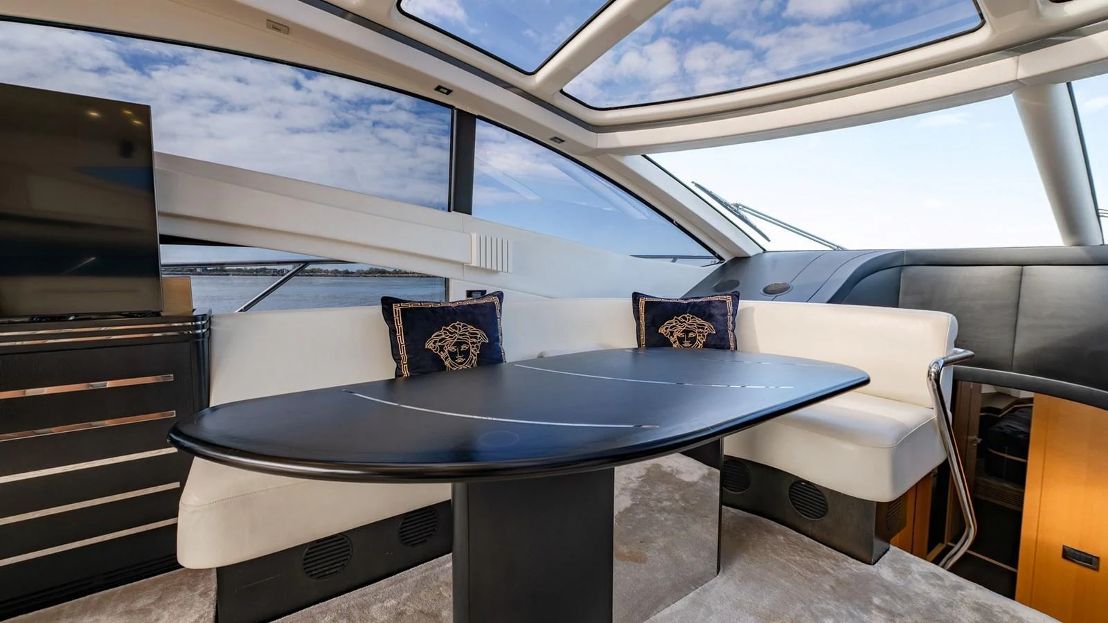 The yacht's salon features a sleek dining area with panoramic windows and luxurious seating. aboard ZAZA Yacht for Sale