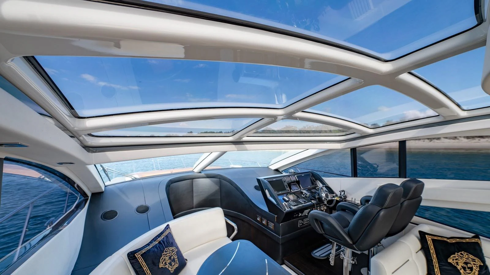 The helm station features luxurious seating and expansive windows for panoramic views. aboard ZAZA Yacht for Sale