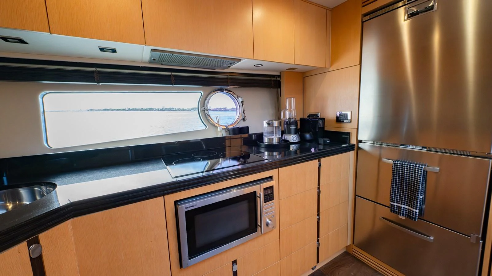 The yacht's galley features modern appliances and a sleek design with ample natural light. aboard ZAZA Yacht for Sale