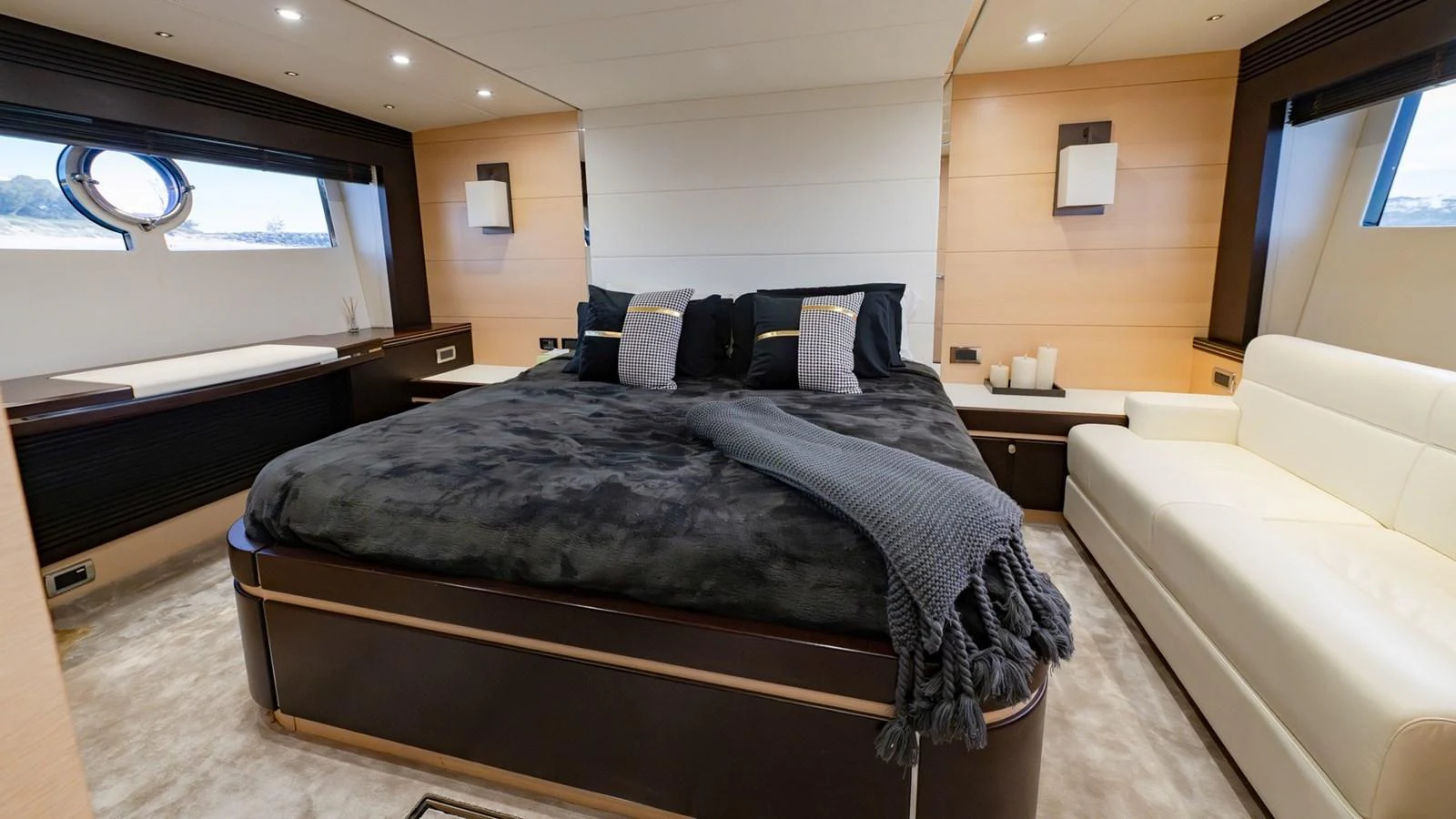The master stateroom features a luxurious bed with plush bedding and ample natural light from the windows. aboard ZAZA Yacht for Sale