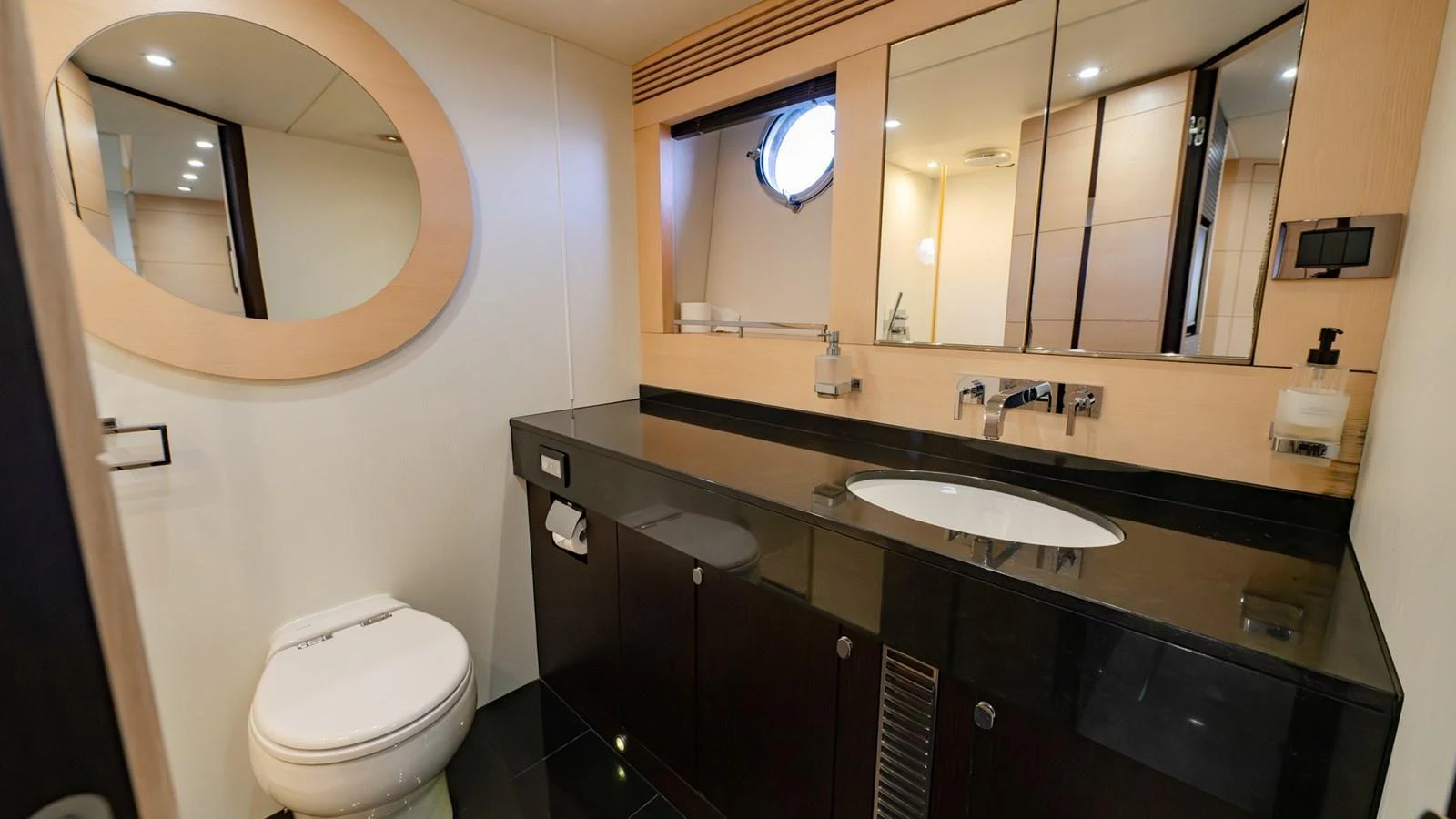 A sleek and modern yacht bathroom with a large mirror and stylish fixtures. aboard ZAZA Yacht for Sale