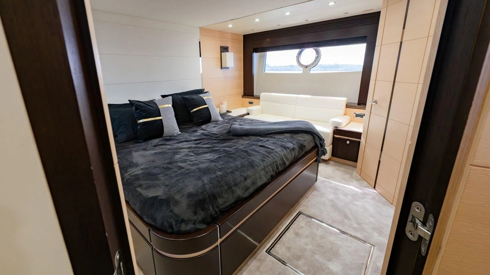 A luxurious stateroom featuring a large bed, plush bedding, and elegant furnishings. aboard ZAZA Yacht for Sale