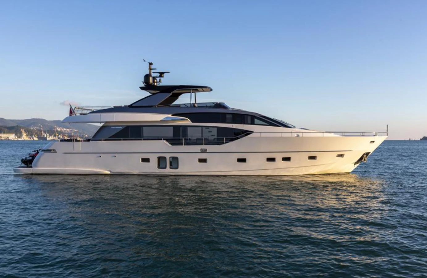A sleek and modern yacht glides gracefully on calm waters under a clear sky. aboard QUEEN MARTINA Yacht for Sale