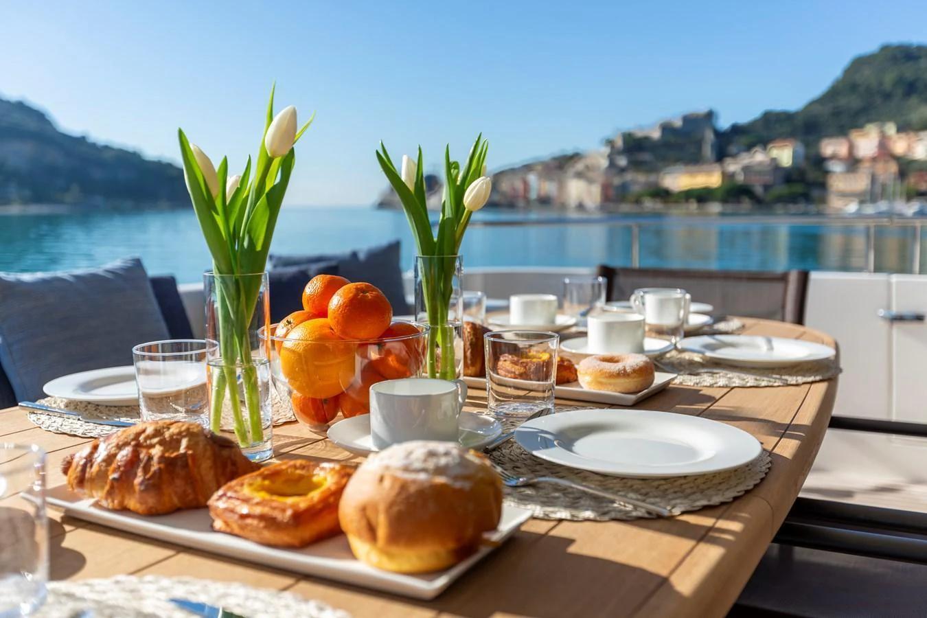 An inviting alfresco dining setup with a scenic view of the coastline. aboard QUEEN MARTINA Yacht for Sale