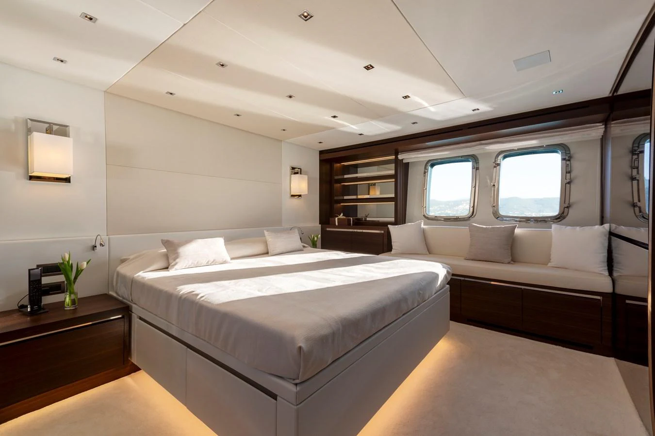 The master stateroom features a spacious bed, modern lighting, and large windows for natural light. aboard QUEEN MARTINA Yacht for Sale
