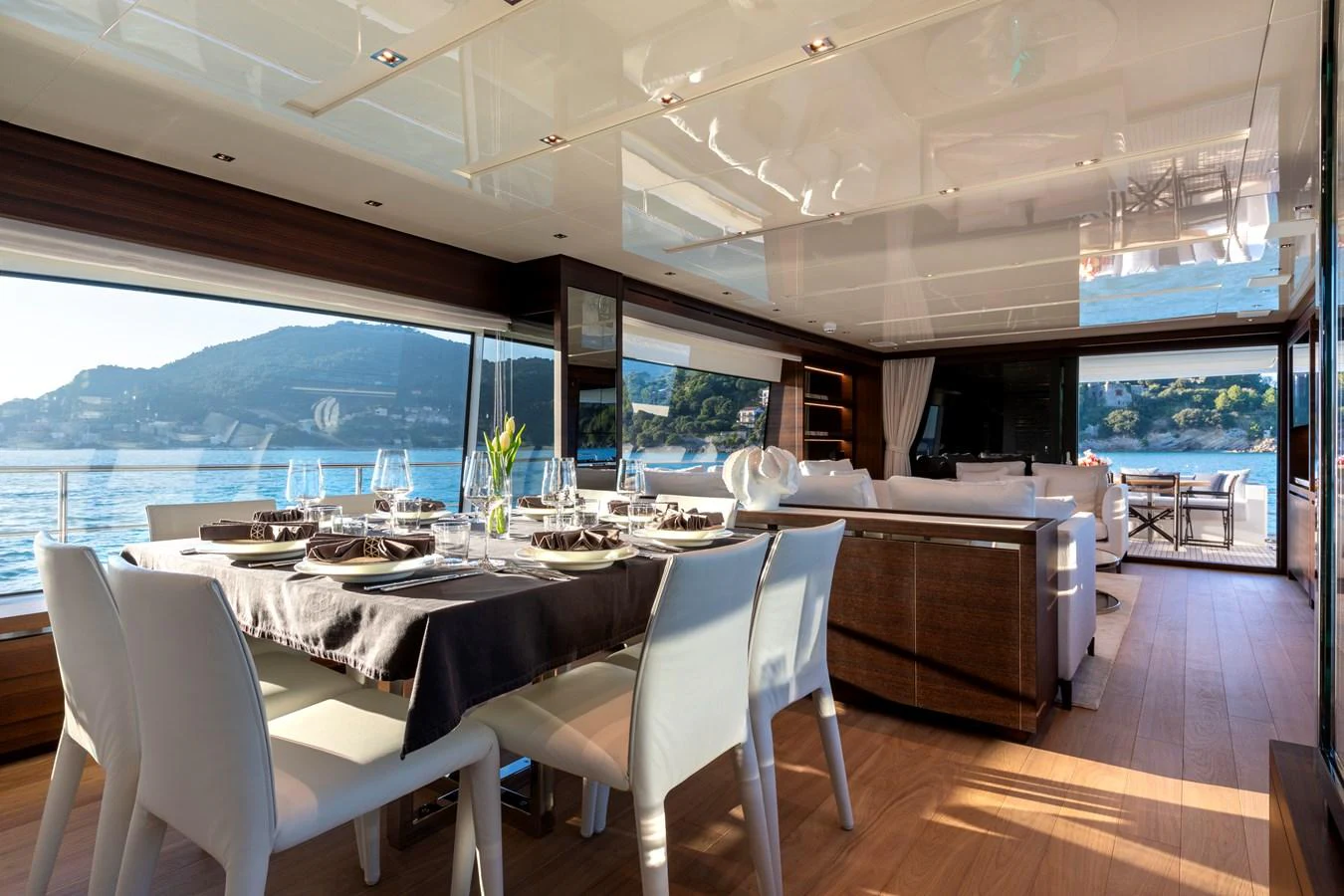 The yacht's dining area offers a luxurious setting with panoramic views of the surrounding waters. aboard QUEEN MARTINA Yacht for Sale