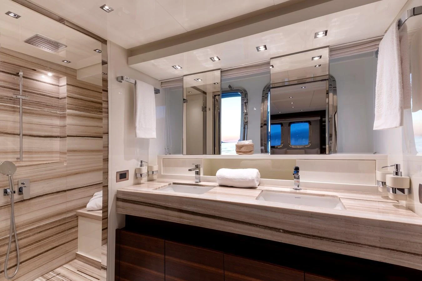 The yacht's bathroom features a luxurious double vanity and a spacious shower area with elegant fixtures. aboard QUEEN MARTINA Yacht for Sale