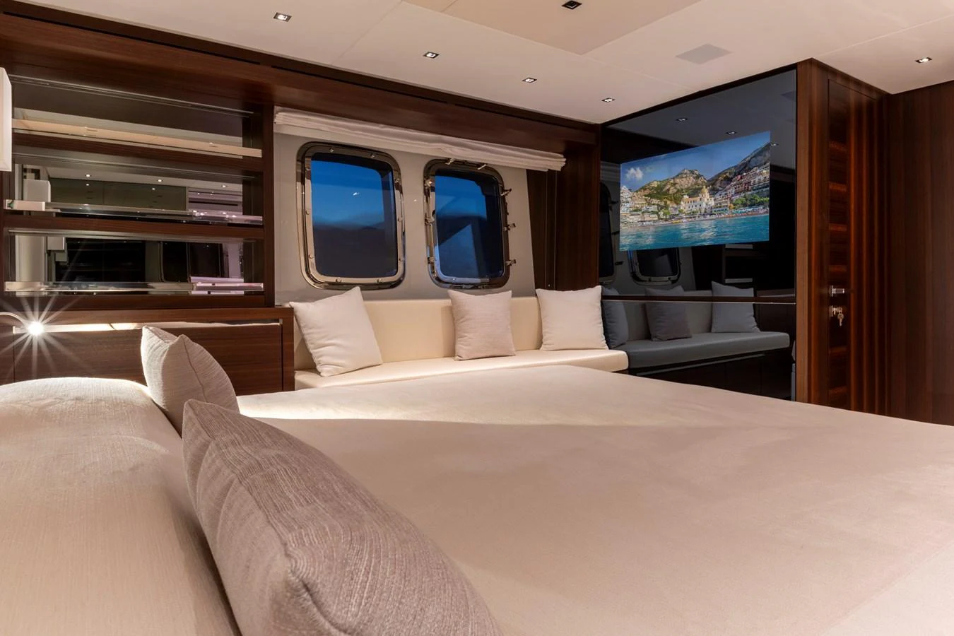 The stateroom features a luxurious bed, elegant wood finishes, and large windows offering scenic views. aboard QUEEN MARTINA Yacht for Sale