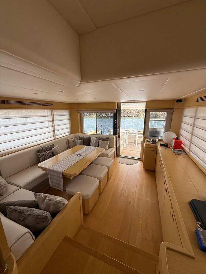 a living room with a wood floor aboard NEVER TOO LATE Yacht for Sale