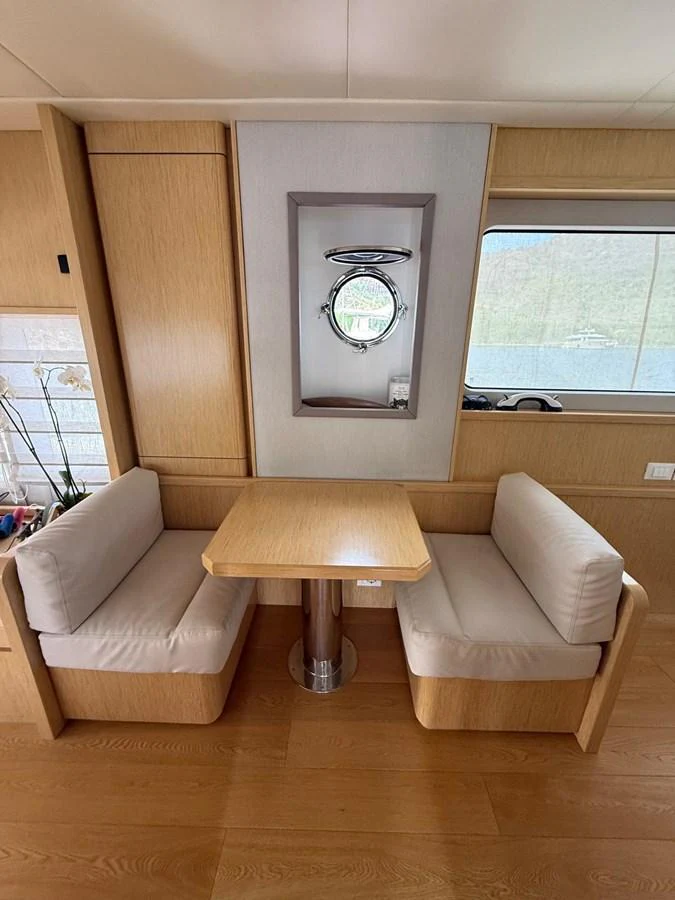 a room with couches and a table aboard NEVER TOO LATE Yacht for Sale