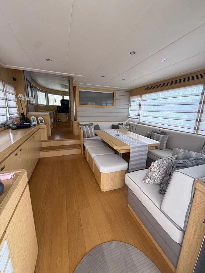 a living room with a couch and a table aboard NEVER TOO LATE Yacht for Sale