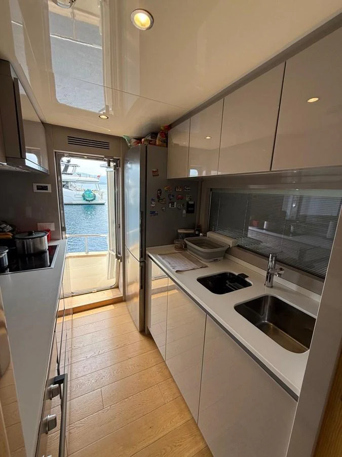 a kitchen with a sliding glass door aboard NEVER TOO LATE Yacht for Sale