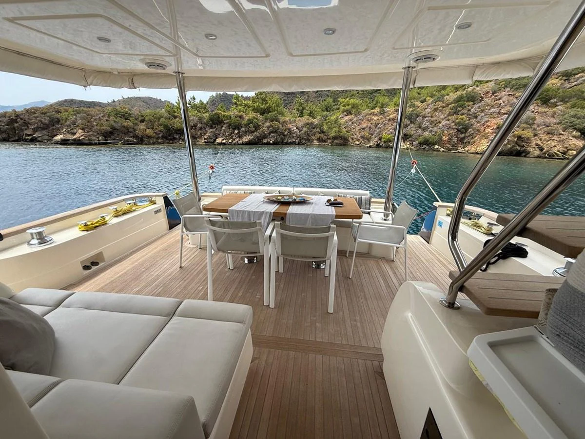 a boat with tables and chairs aboard NEVER TOO LATE Yacht for Sale