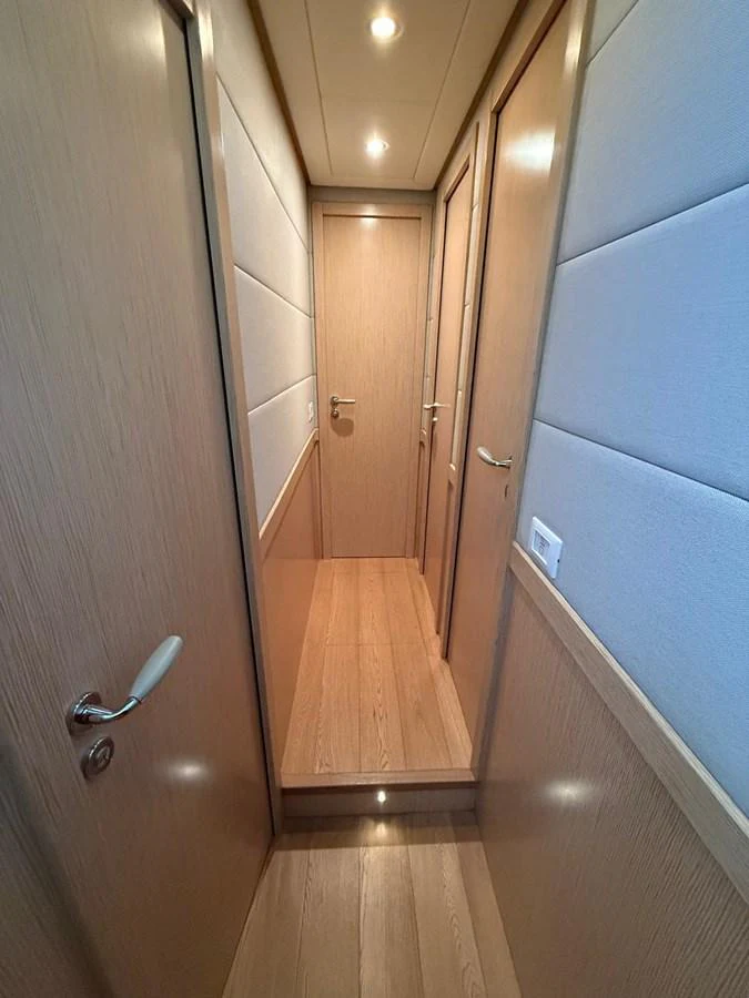 a hallway with doors aboard NEVER TOO LATE Yacht for Sale