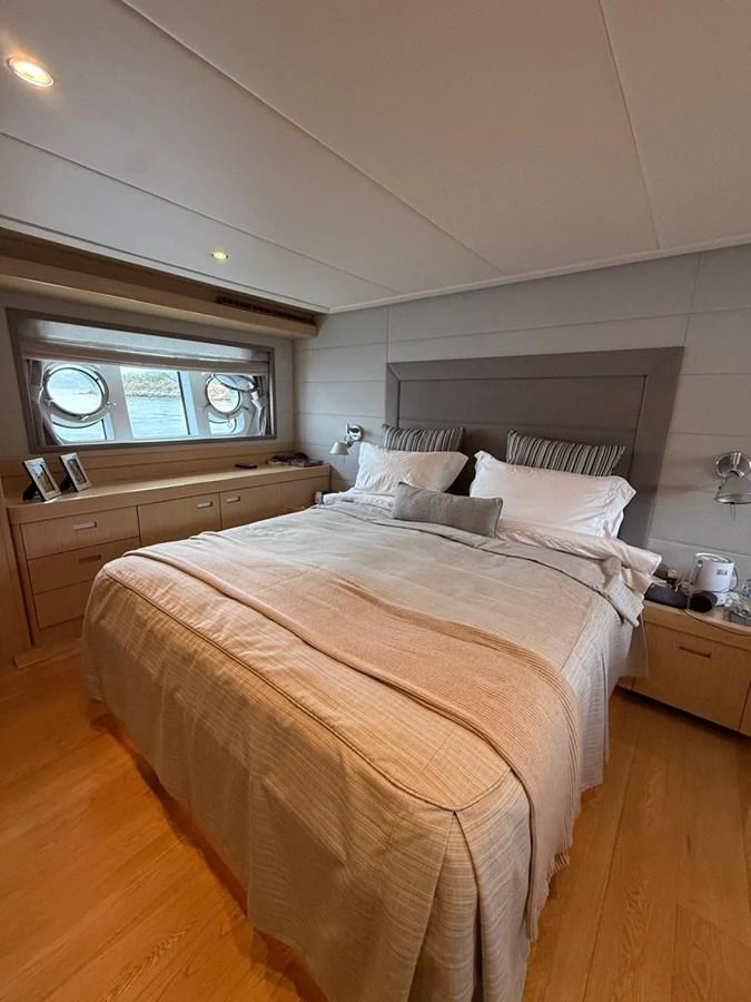 a bed with white sheets aboard NEVER TOO LATE Yacht for Sale