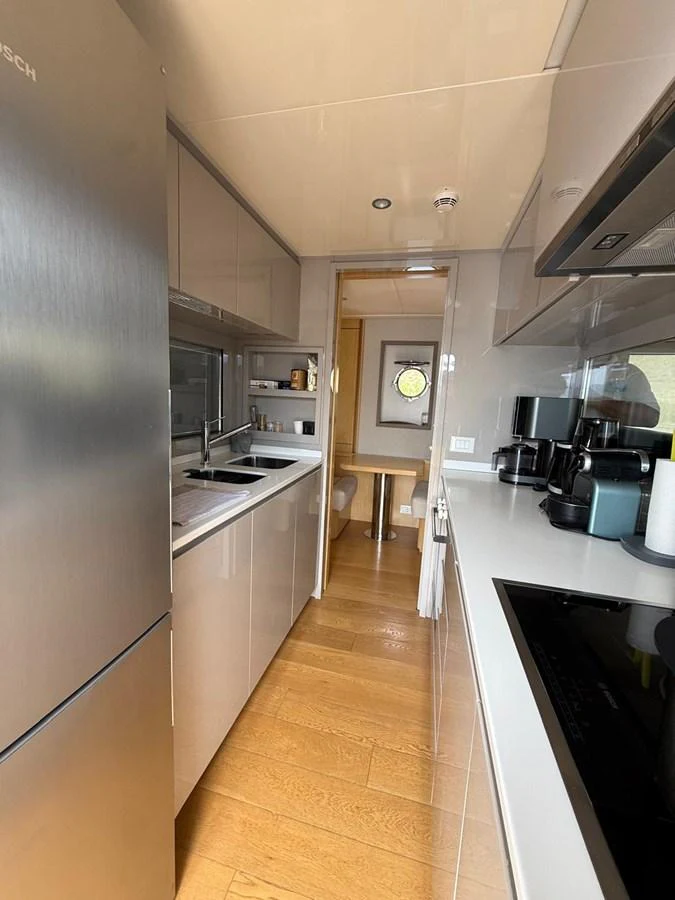 a kitchen with a stainless steel stove aboard NEVER TOO LATE Yacht for Sale