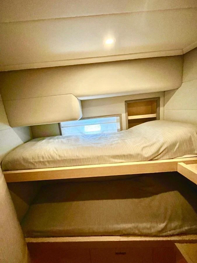a bed with a laptop on top aboard NEVER TOO LATE Yacht for Sale