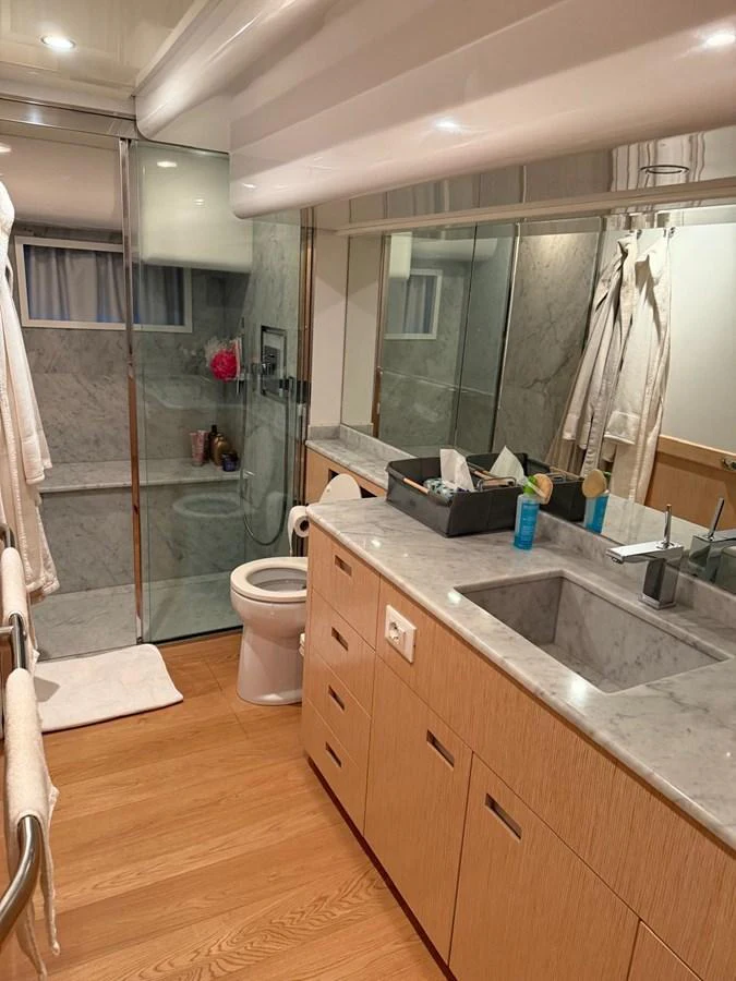 a bathroom with a glass shower aboard NEVER TOO LATE Yacht for Sale