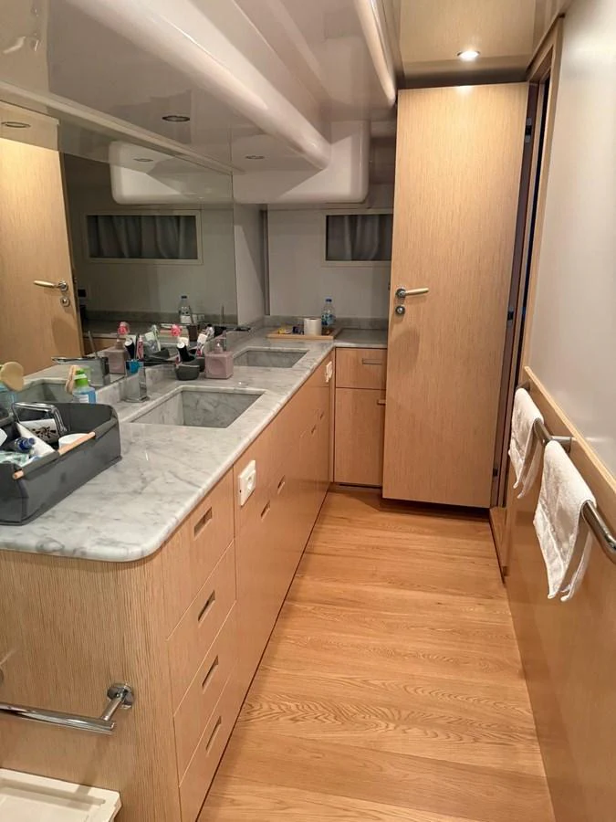 a bathroom with a countertop sink and cabinets aboard NEVER TOO LATE Yacht for Sale
