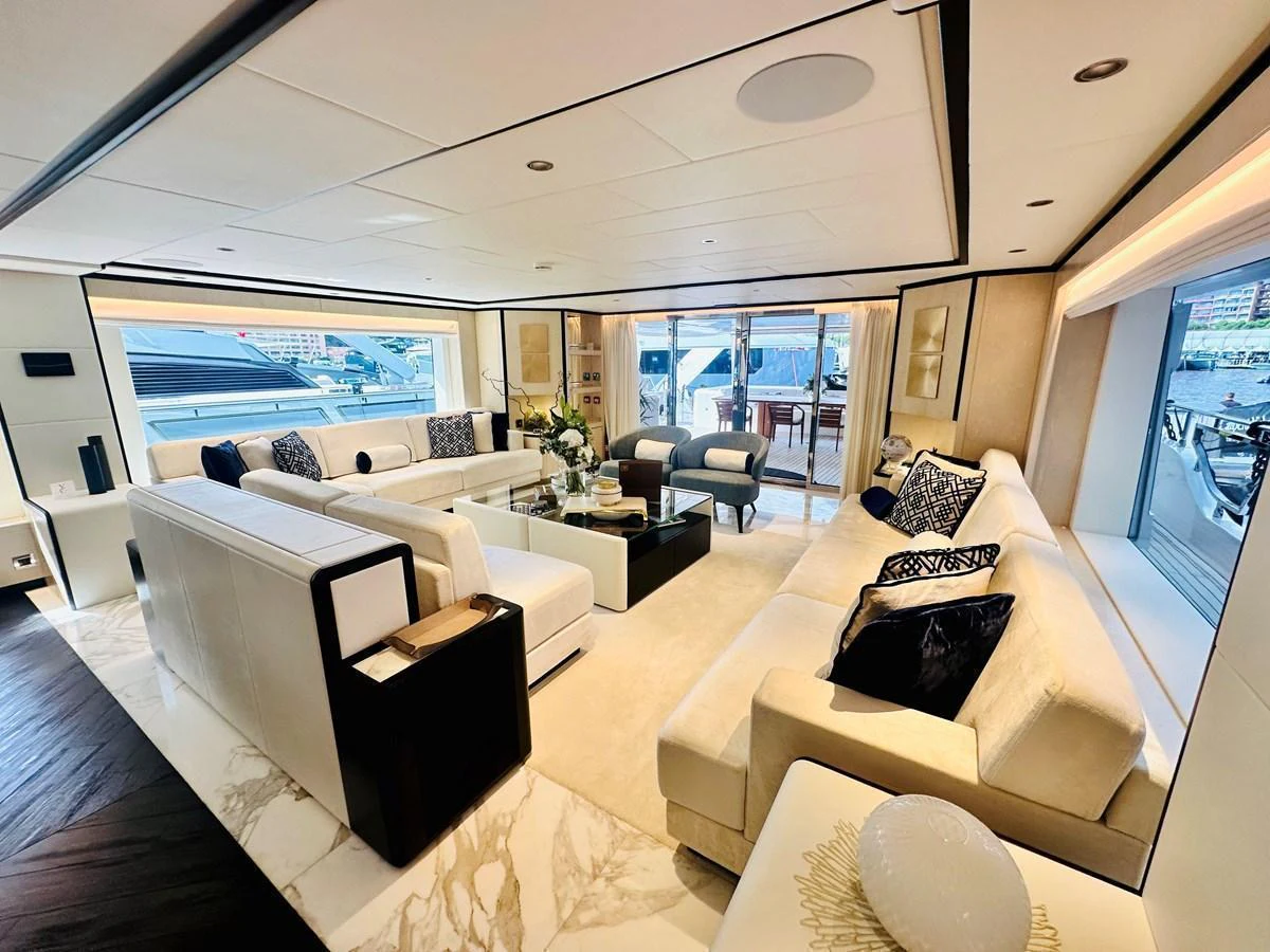 The salon offers a spacious and luxurious seating area with elegant decor and large windows providing stunning views. aboard OPTIMISM Yacht for Sale