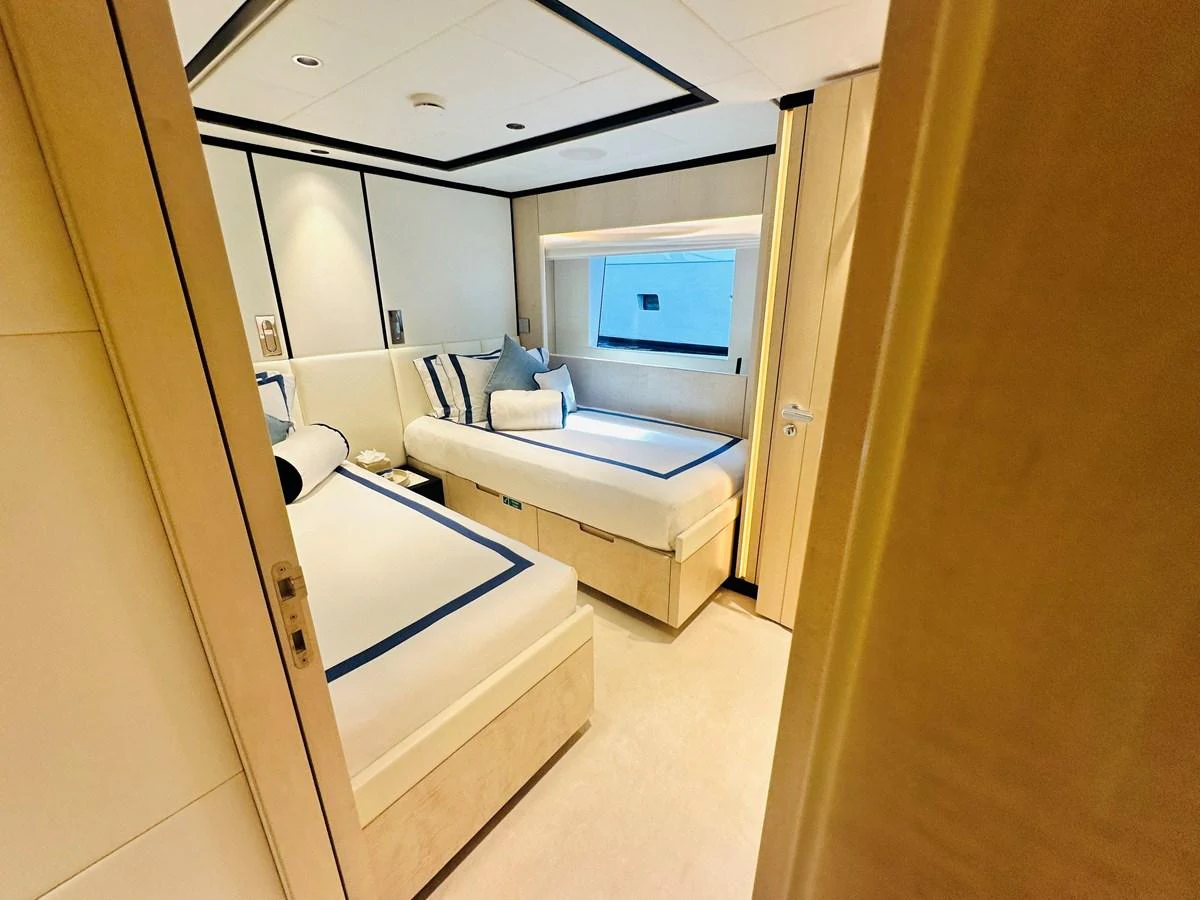 a room with a bed and a window aboard OPTIMISM Yacht for Sale