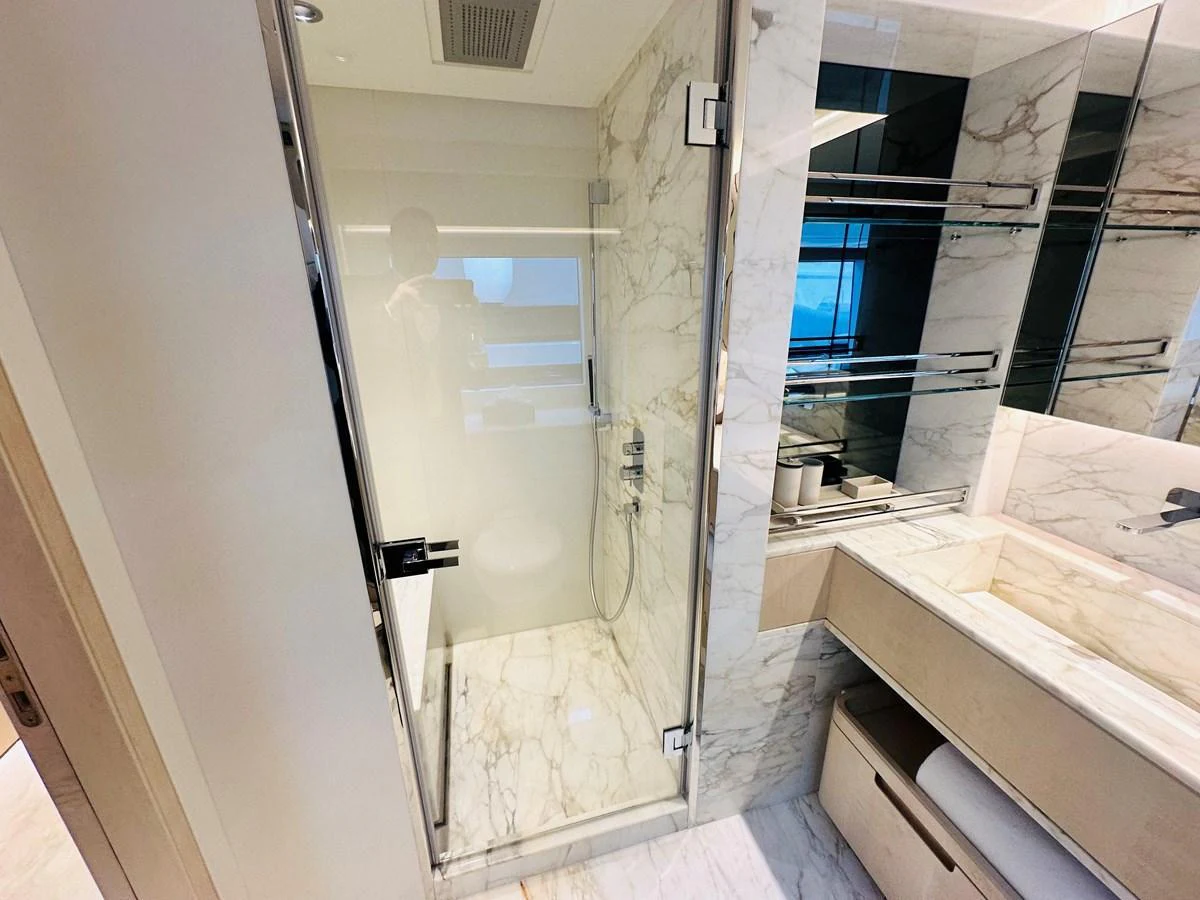 The yacht's bathroom features elegant marble surfaces and modern fixtures. aboard OPTIMISM Yacht for Sale