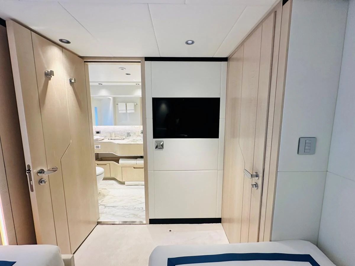 a room with a tv and a door aboard OPTIMISM Yacht for Sale