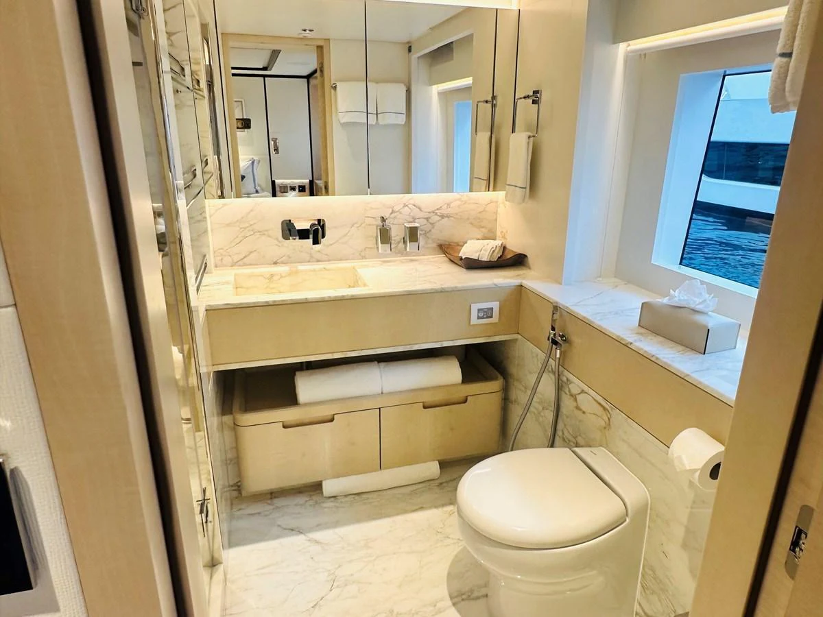 The yacht's bathroom features elegant marble surfaces and modern fixtures. aboard OPTIMISM Yacht for Sale